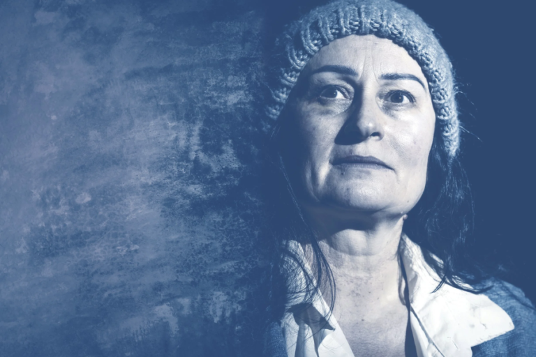 Myra, a homeless woman in a wool hat