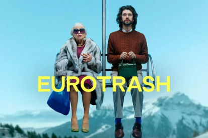 Two people on a ski lift with snow-capped mountains in the background; bold yellow text “EUROTRASH” overlays the scene.