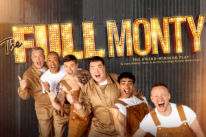 Promotional photo: six men in tan overalls cheer in front of a lit 'The Full Monty' marquee sign against a dark wall.