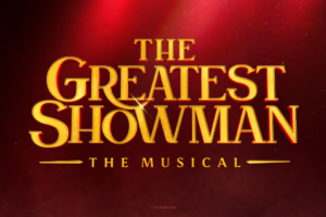 Gold-lettered title 'The Greatest Showman' with 'The Musical' subtitle on a red gradient background, resembling a promotional poster.